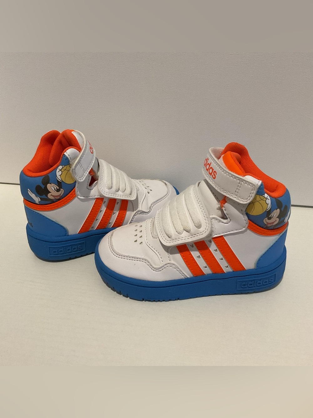 adidas Kids White Sneakers with Orange Stripes and Blue Soles